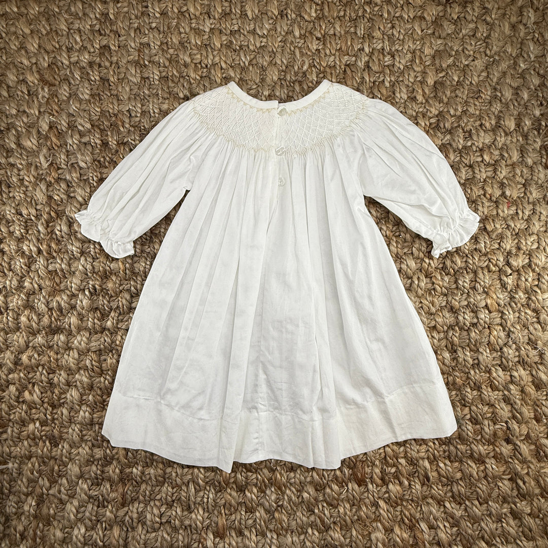 Smocked Cross Dress in White with Cream Crosses and Long Sleeves Smocked Cross Dress in White with Cream Crosses and Long Sleeves